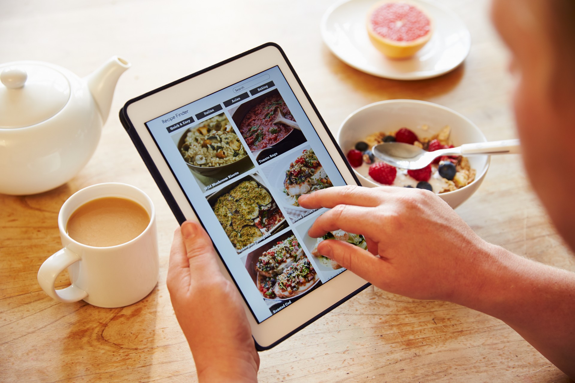 Person At Breakfast Looking At Recipe App On Digital Tablet